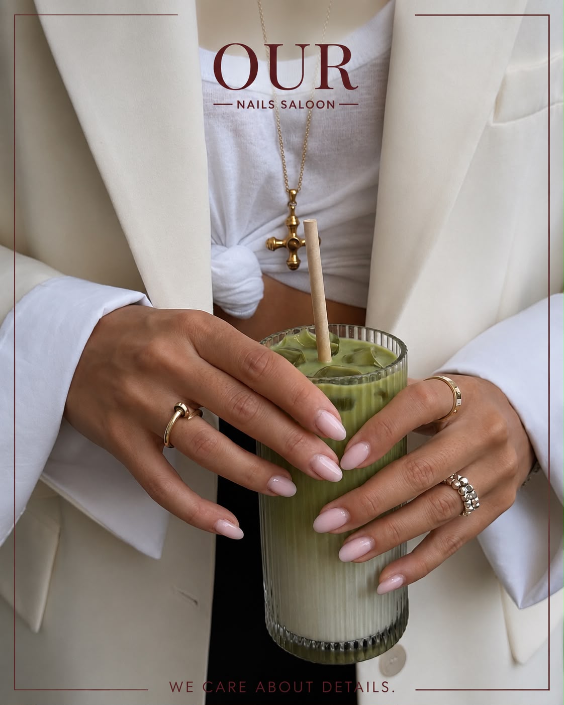 Soft pink almond nails holding an iced matcha in cream tailoring